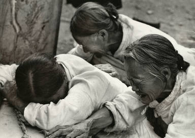 1952 - In a Korean village, a wife, mother, and grandmother lament the death of their boy in guerilla warfare